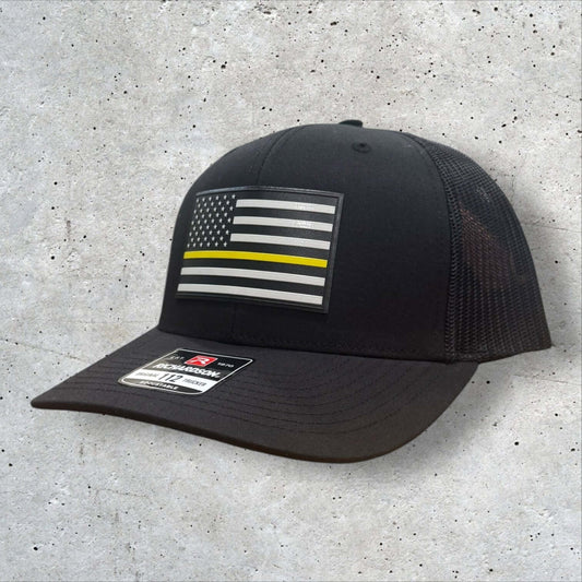 Thin Yellow Line Hat featuring a UV-printed American flag patch, durable black Richardson 112 trucker design.