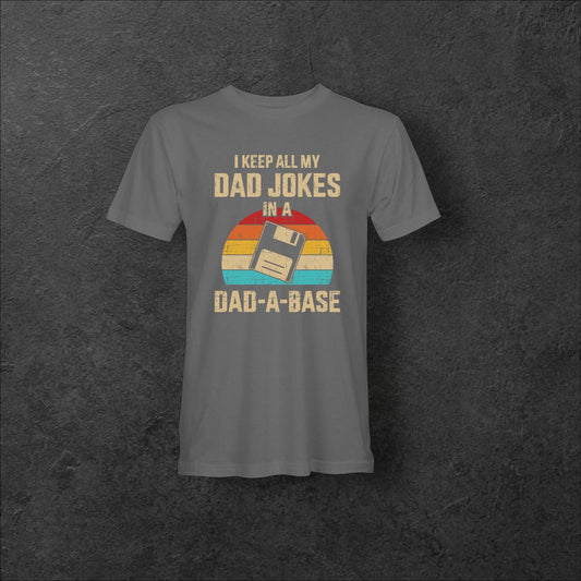 Gray retro Dad-A-Base tee featuring floppy disk design and phrase about storing dad jokes.