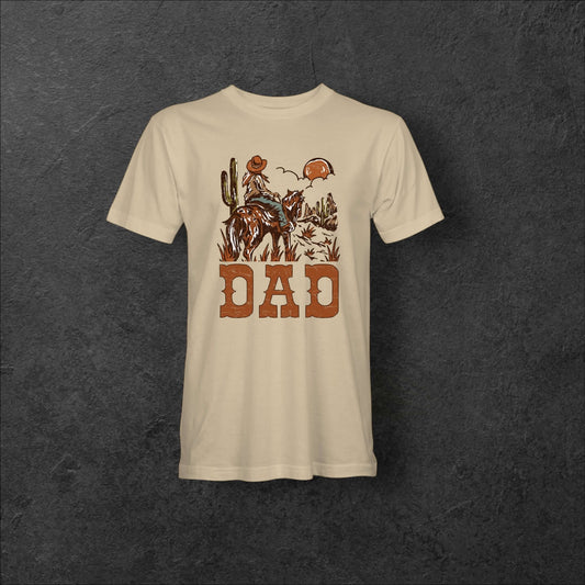 Western Dad Tee featuring a rugged dad on horseback in a desert scene, perfect for outdoor-loving fathers.